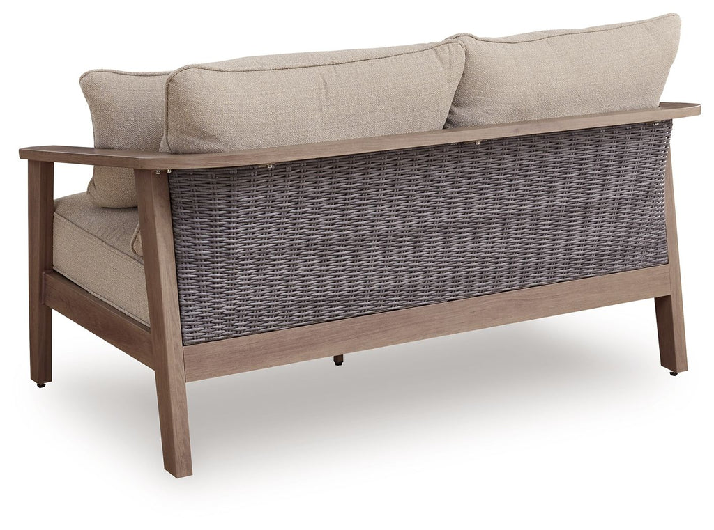 Natural beige loveseat with cushion, striped back pillows, wicker wrap base, armrests