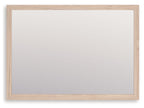 Tan wood-framed rectangular bedroom mirror with clear glass panel