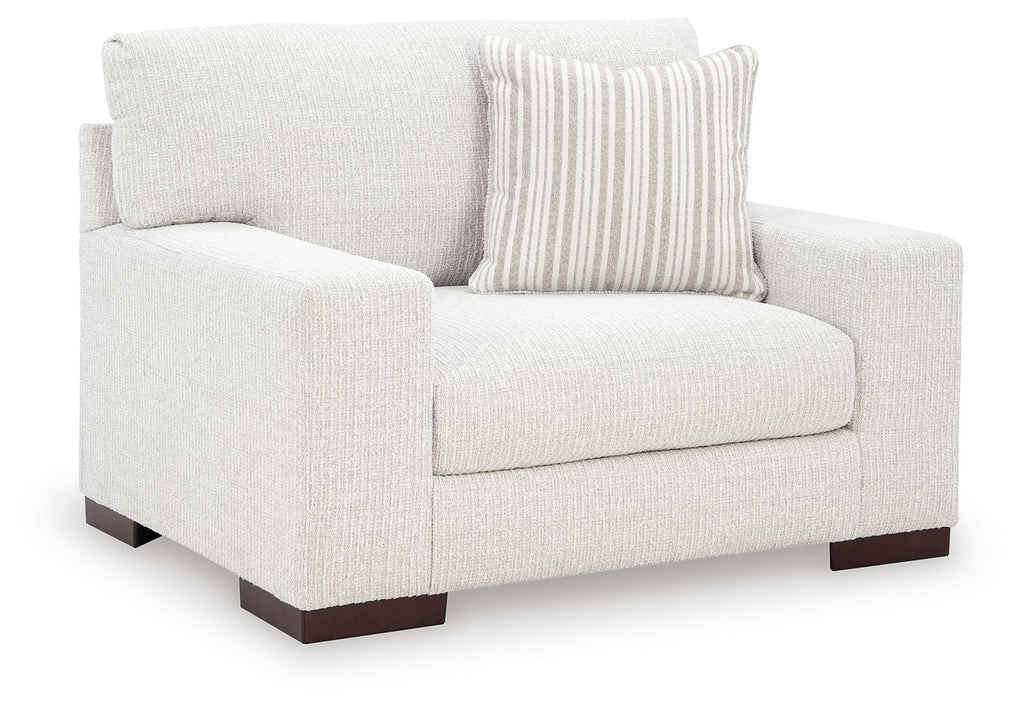 Frosted chair and a half, light fabric upholstery, striped pillow, dark wooden legs