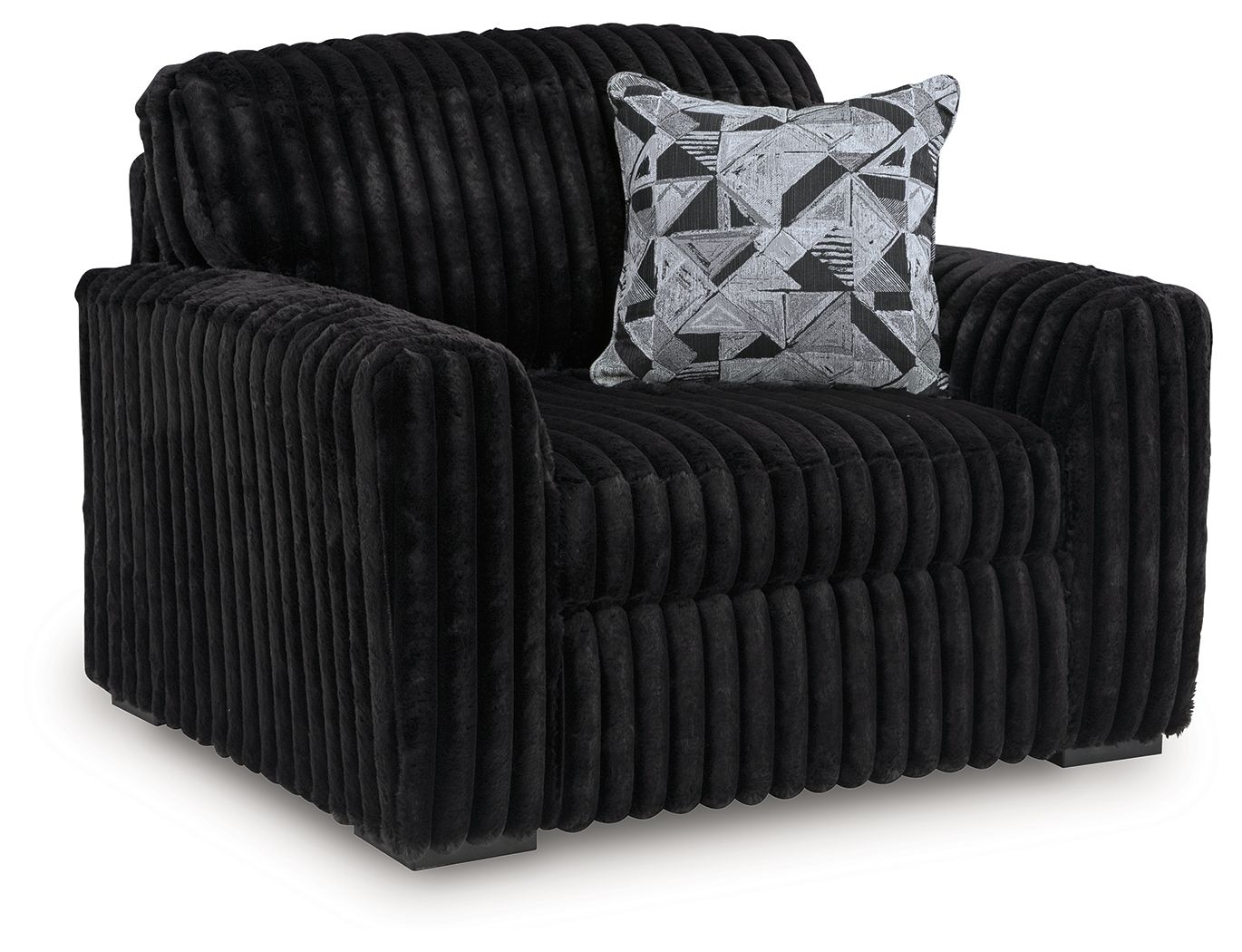 Black chair-and-a-half, ribbed upholstery, geometric throw pillow
