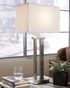 Metal table lamp with light beige shade and brushed silver finish stand