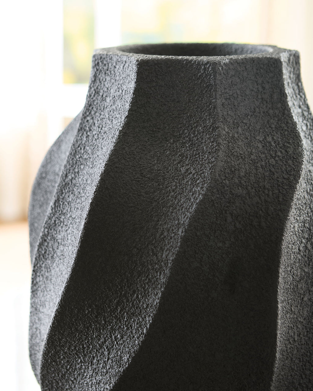 Black textured vase with fluted stripe detail and wide round opening