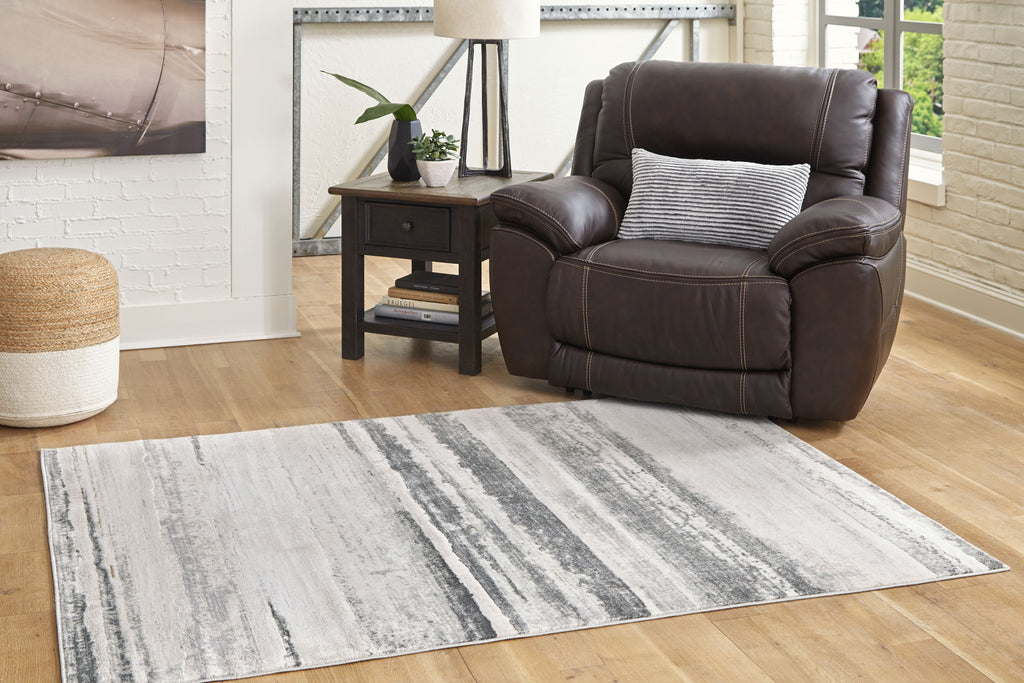 Gray abstract striped area rug on hardwood floor