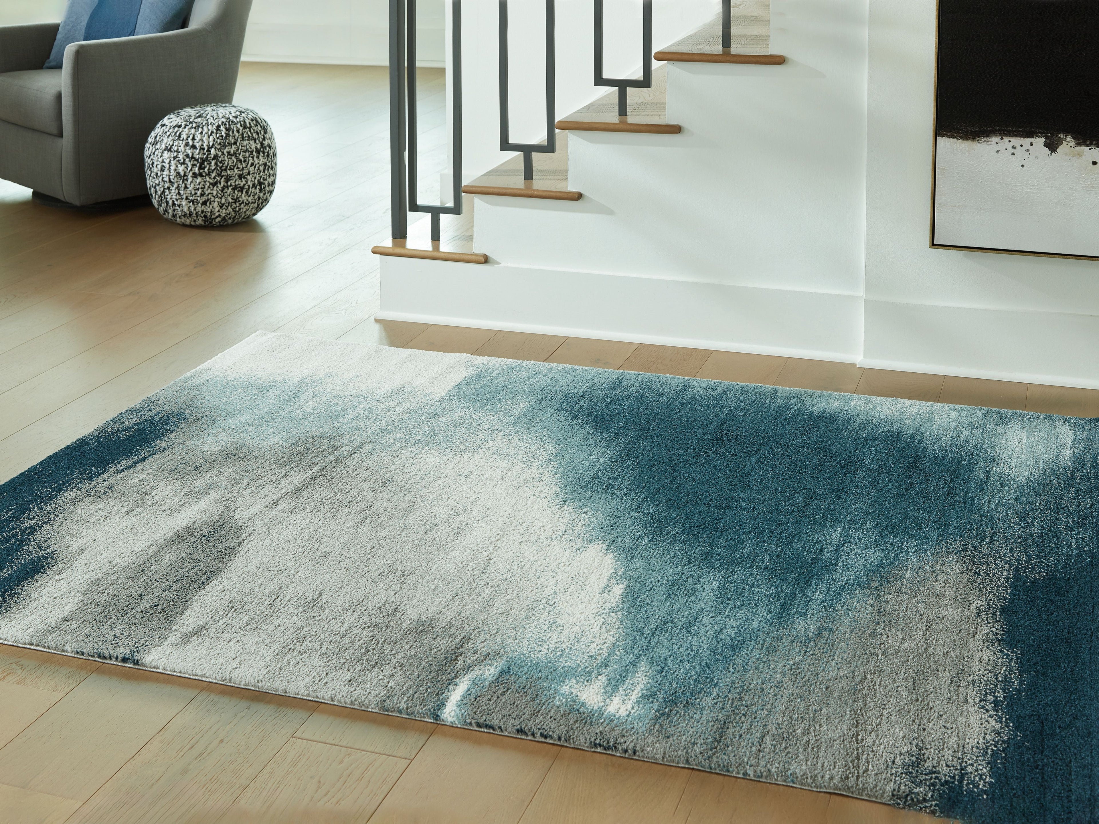 Blue abstract area rug with cream highlights, distressed texture