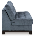 Dark navy armless loveseat with rolled back, tufted seat, and wooden feet
