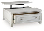 White lift-top table with a hidden compartment and front drawer with metal knobs.