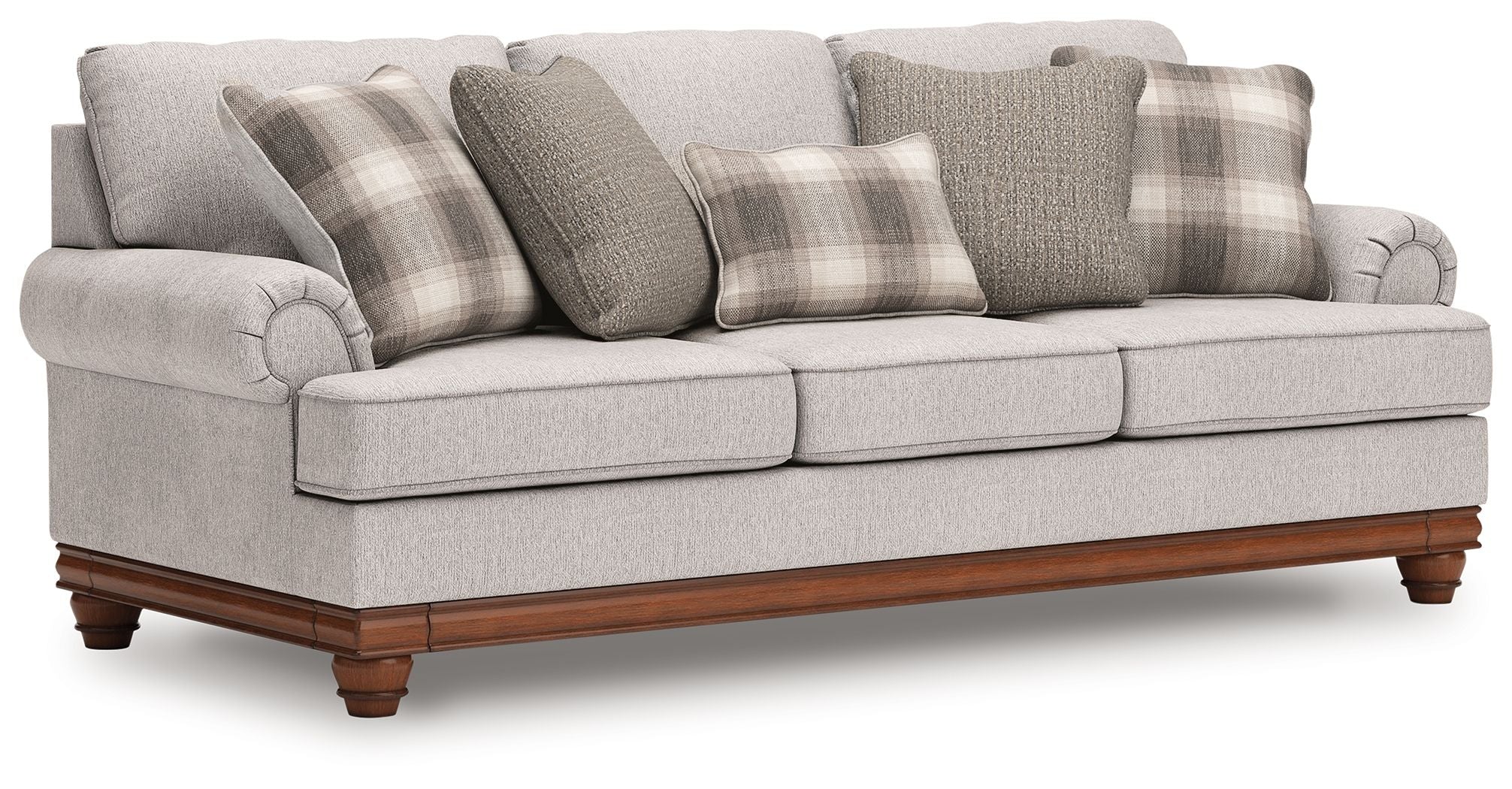 Light gray sofa with mixed plaid and solid throw pillows, wide armrests, wooden legs