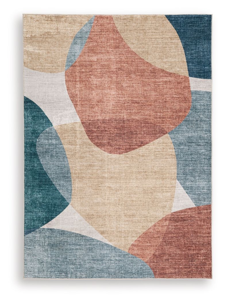 Geometric washable rug close-up with blue, coral, beige, and gray block shapes