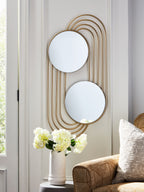 Gold-finish accent wall mirror mounted with two round mirrors and arched metal lines