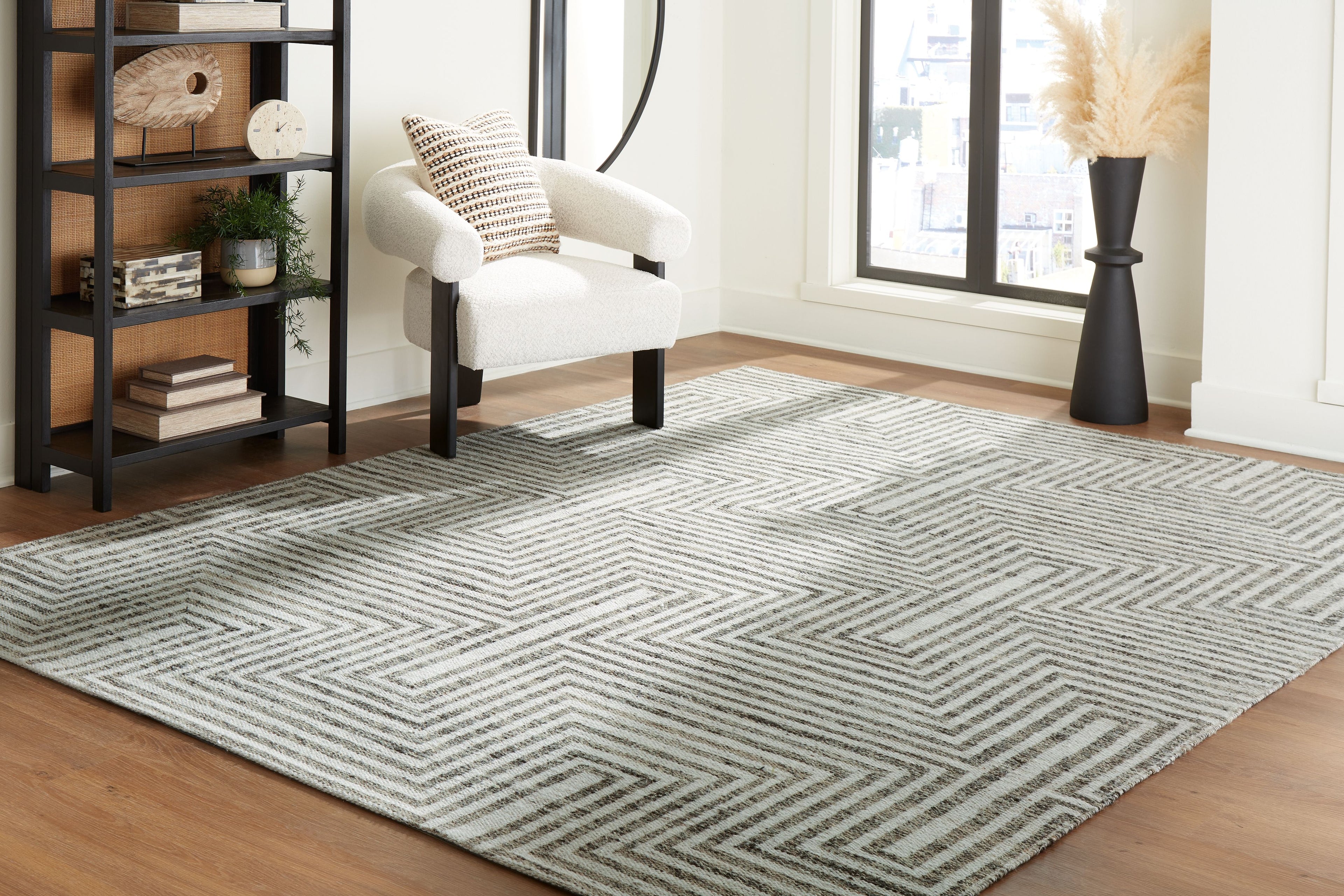 Gray chevron-pattern area rug laid flat on wood floor