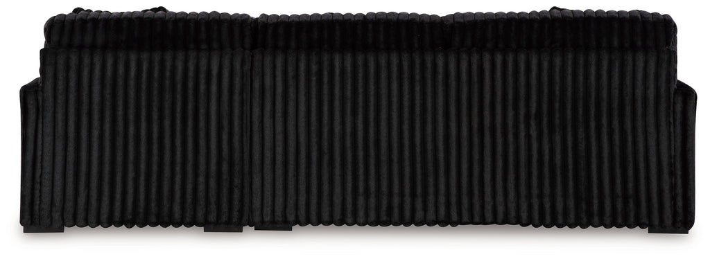 Black sectional sofa with ribbed upholstery and thick seat-back cushion