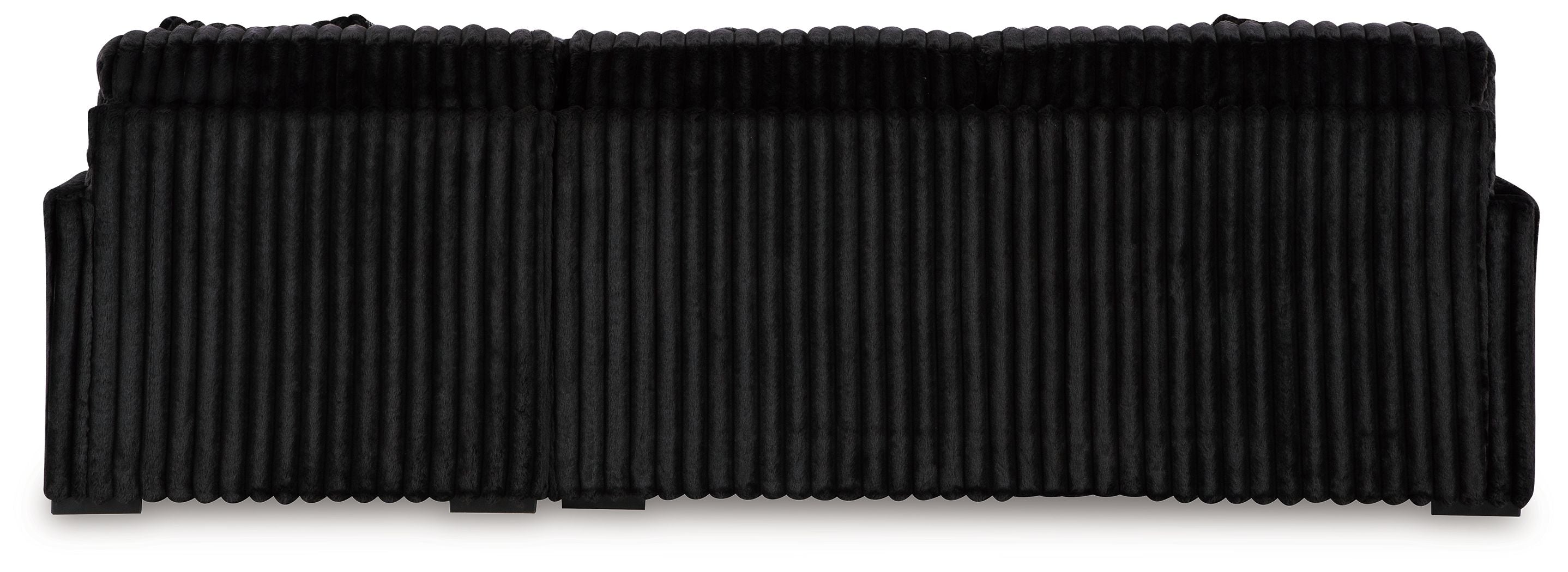 Black sectional sofa with ribbed upholstery and thick seat-back cushion