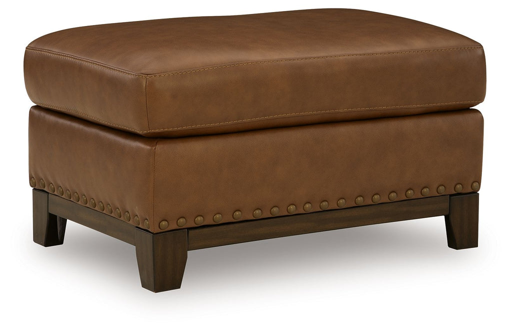 Saonara amber ottoman with tufted top, faux leather-look, studded trim, dark wooden legs