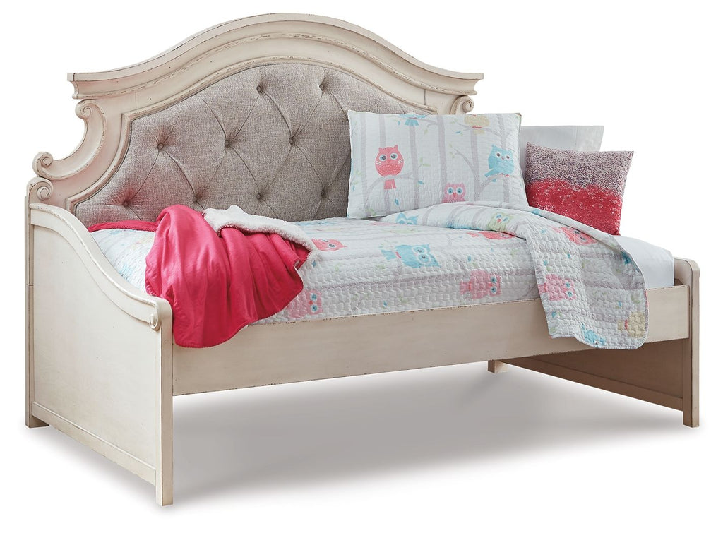 Chipped white twin day bed with gray tufted headboard and light quilt, pink throw and pillows