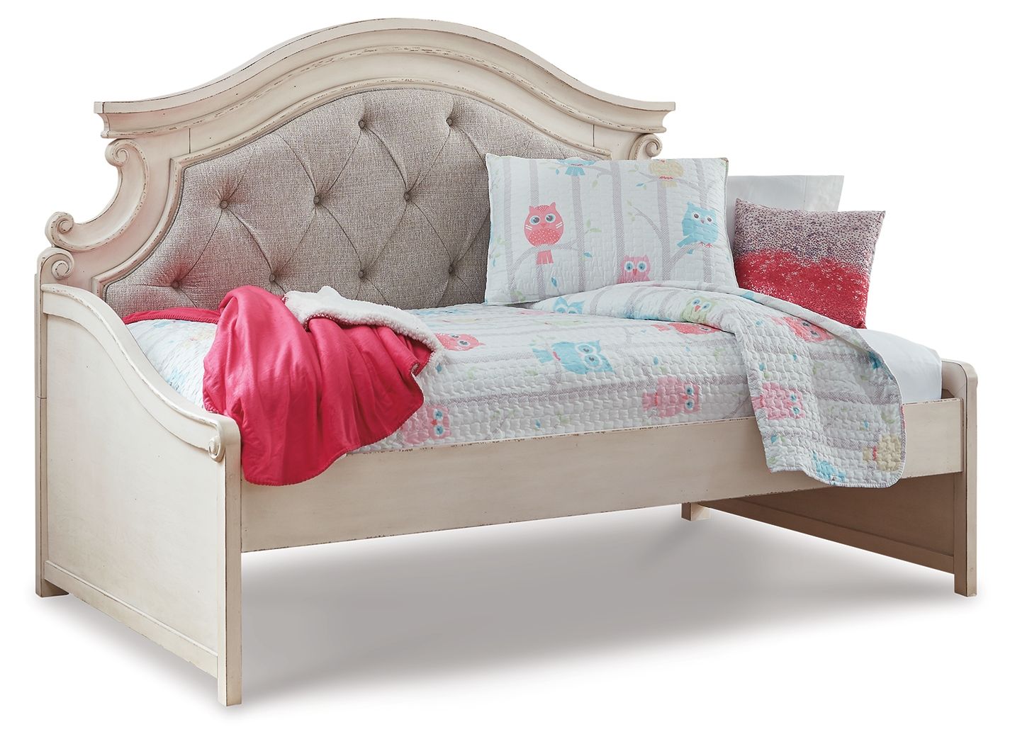Chipped white twin day bed with gray tufted headboard and light quilt, pink throw and pillows