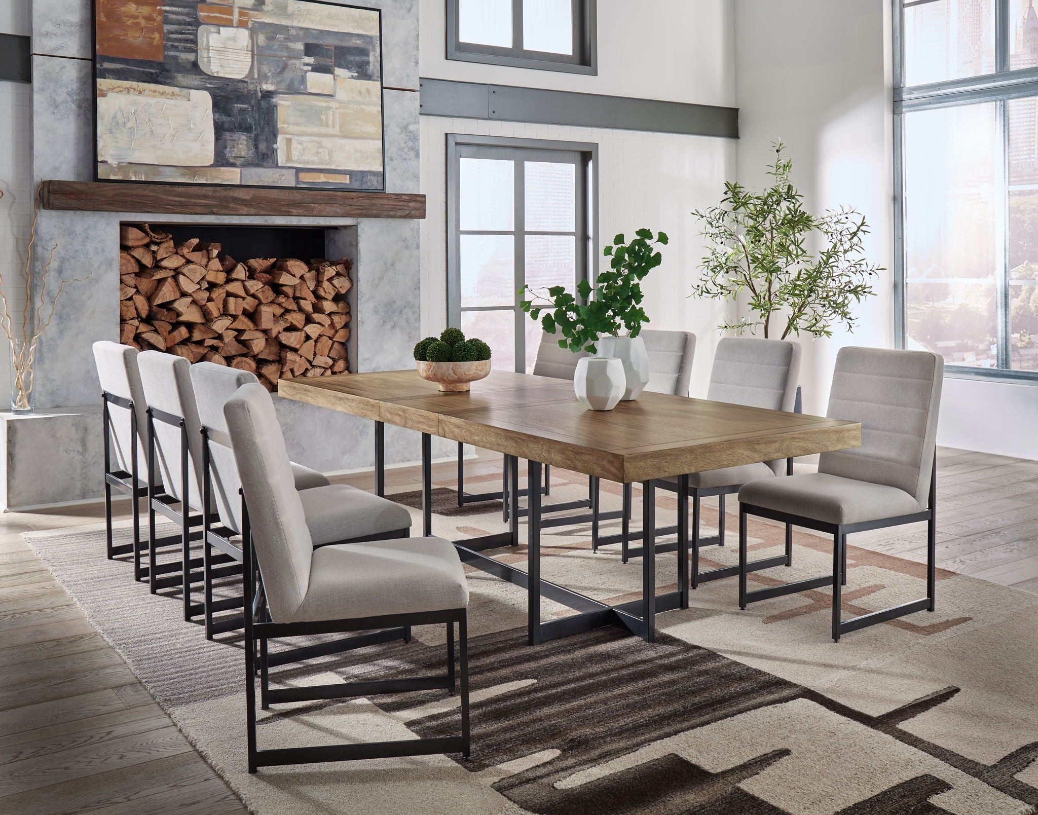 Dining set with light brown table and six gray upholstered chairs, black frames.