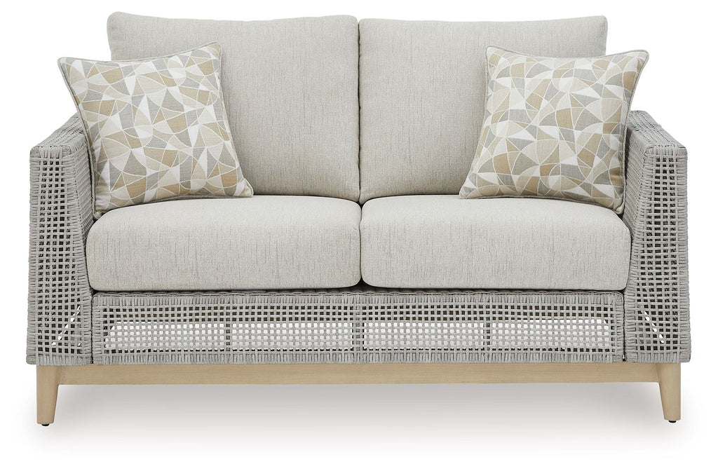 Gray woven loveseat with two seat cushions and three light patterned throw pillows
