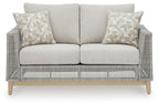 Gray woven loveseat with two seat cushions and three light patterned throw pillows