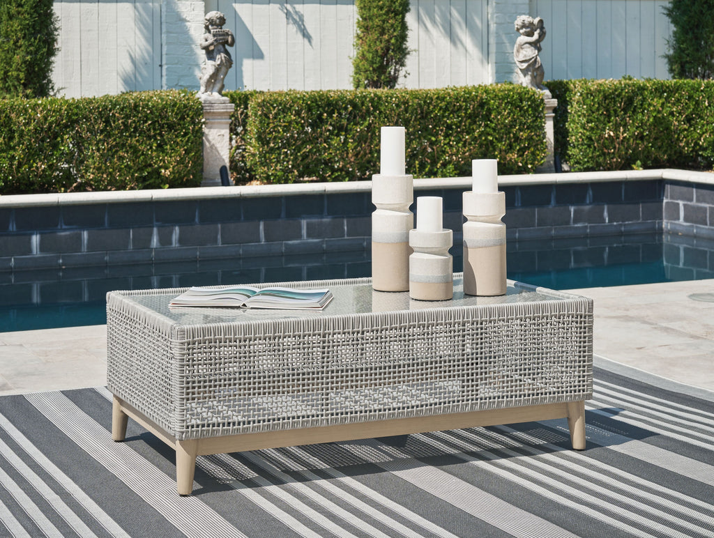 Gray rectangular cocktail table with woven mesh surface and wooden legs
