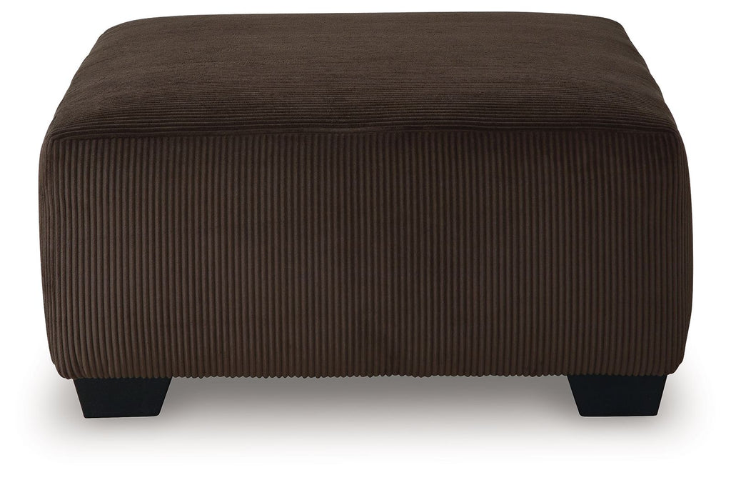 Oversized accent ottoman in chocolate-brown ribbed upholstery with short dark feet