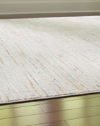 Light beige rug with short pile surface and subtle speckled flecks near edge