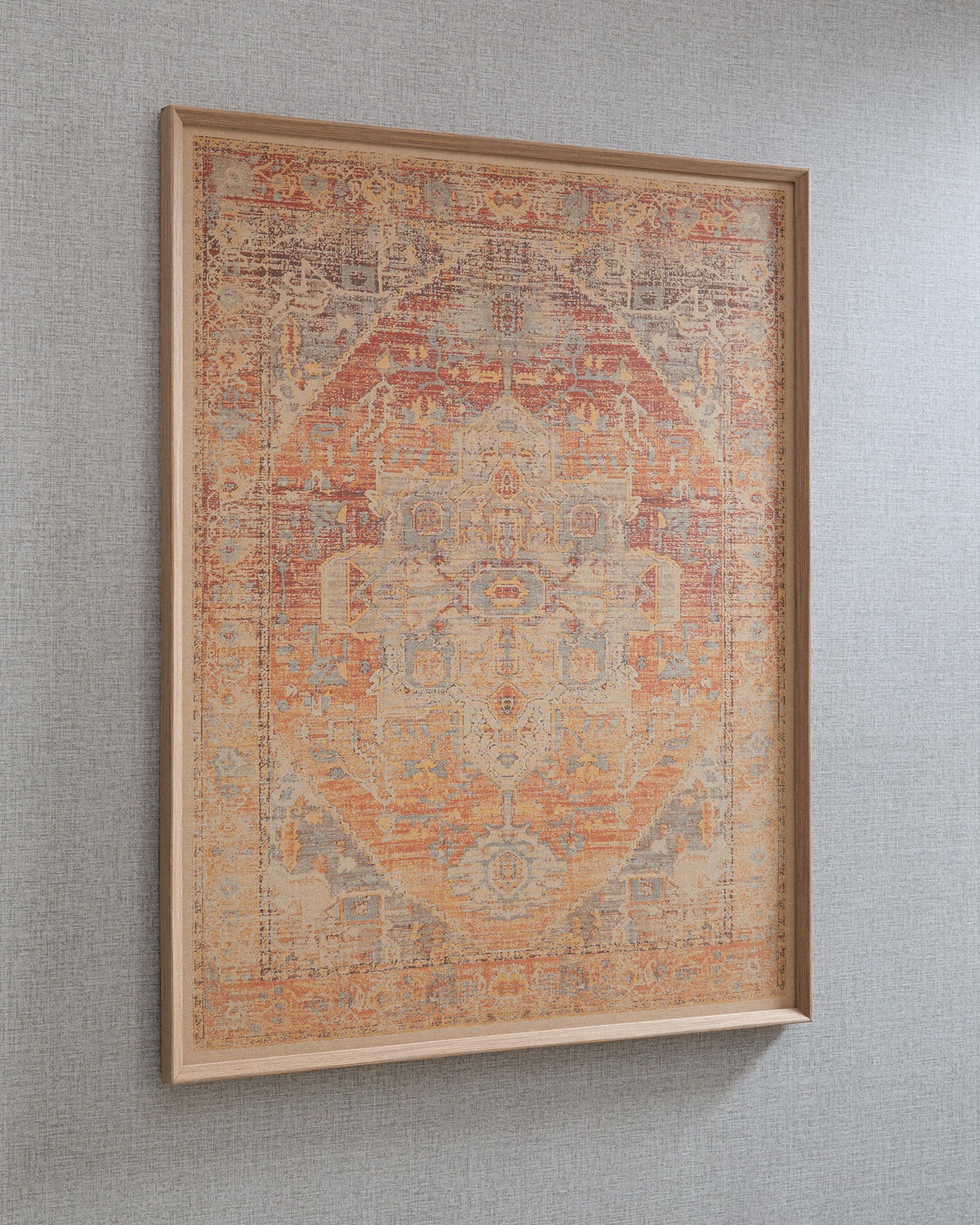 Framed wall art with red-orange geometric motif and muted blue accents on wall