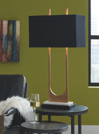Brass table lamp with black rectangular shade, dark base, and curved U metal support