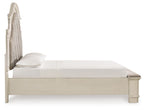 Storage bed side view with upholstered headboard and smooth white platform