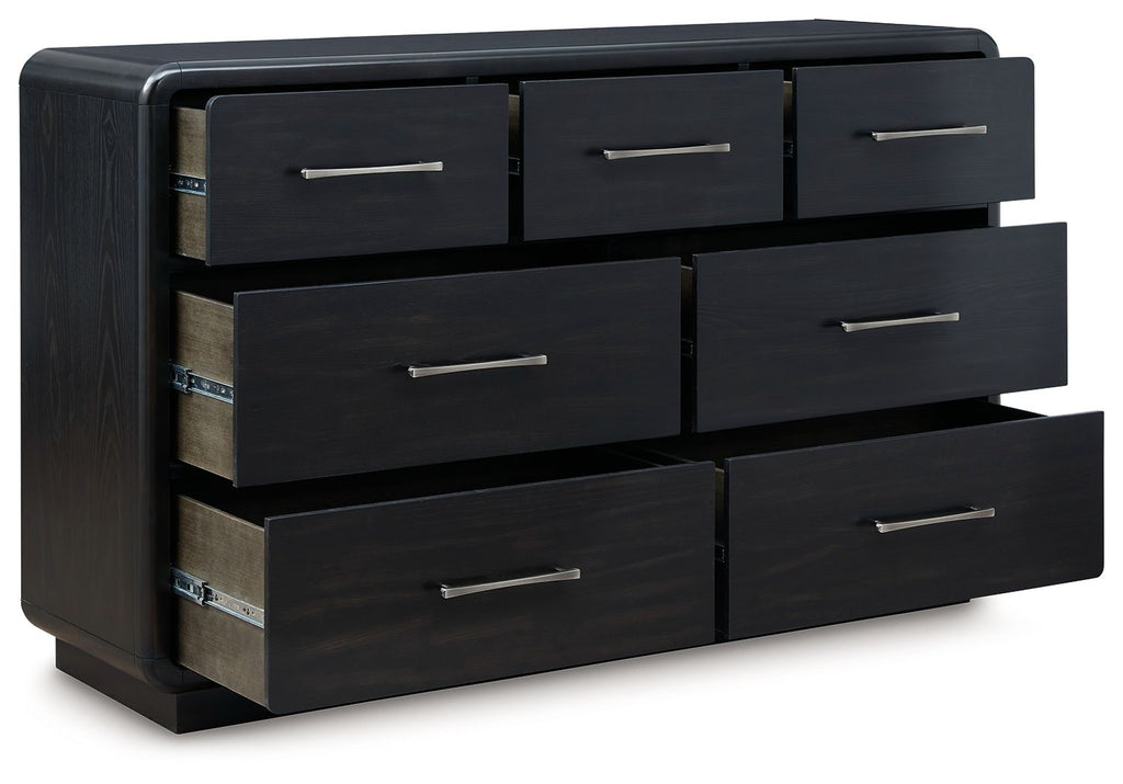 Black dresser with multiple drawers and metal bar handles