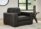Dark brown upholstered chair with tufted back and squared arms, front three-quarter view