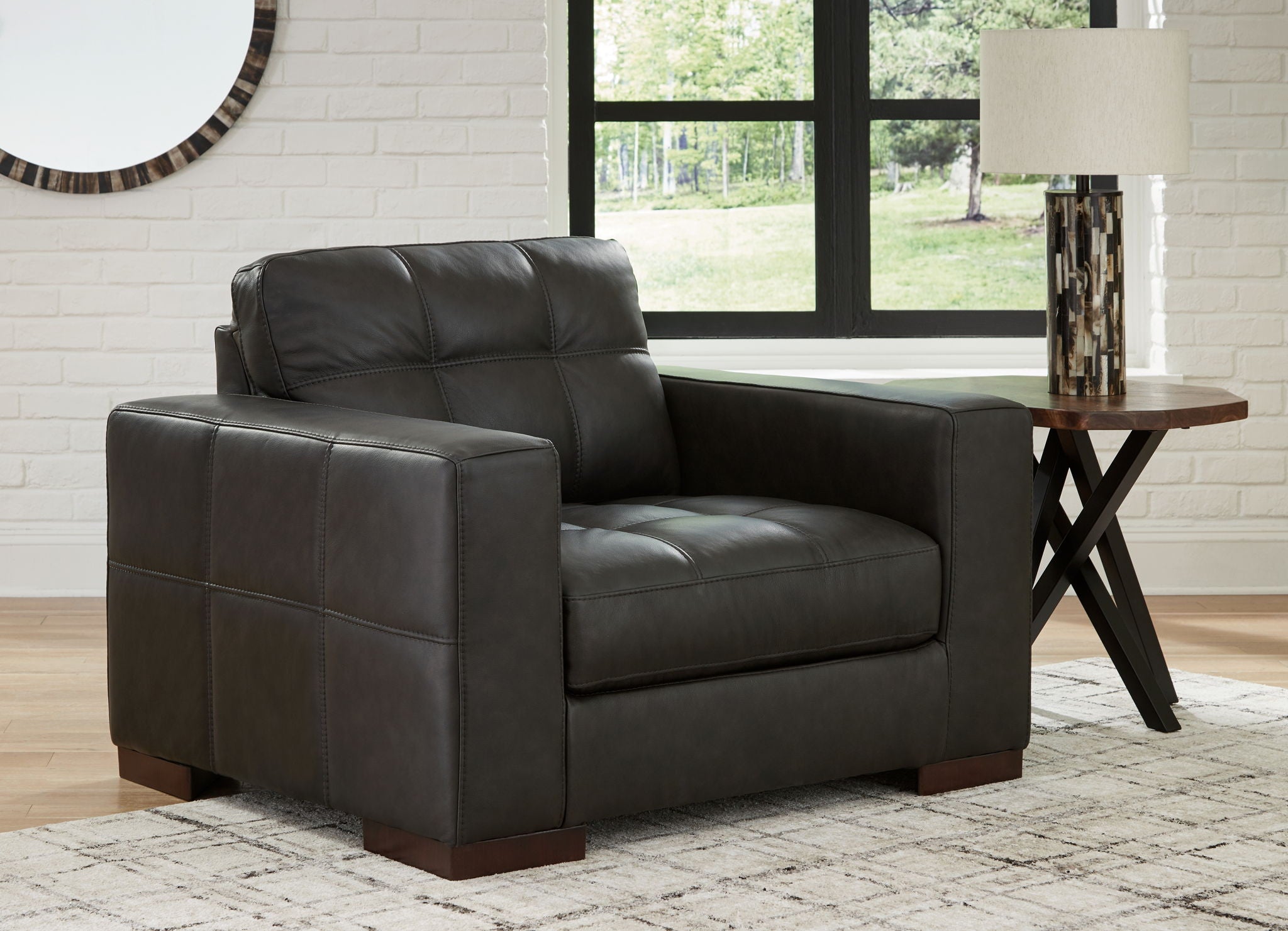 Dark brown upholstered chair with tufted back and squared arms, front three-quarter view