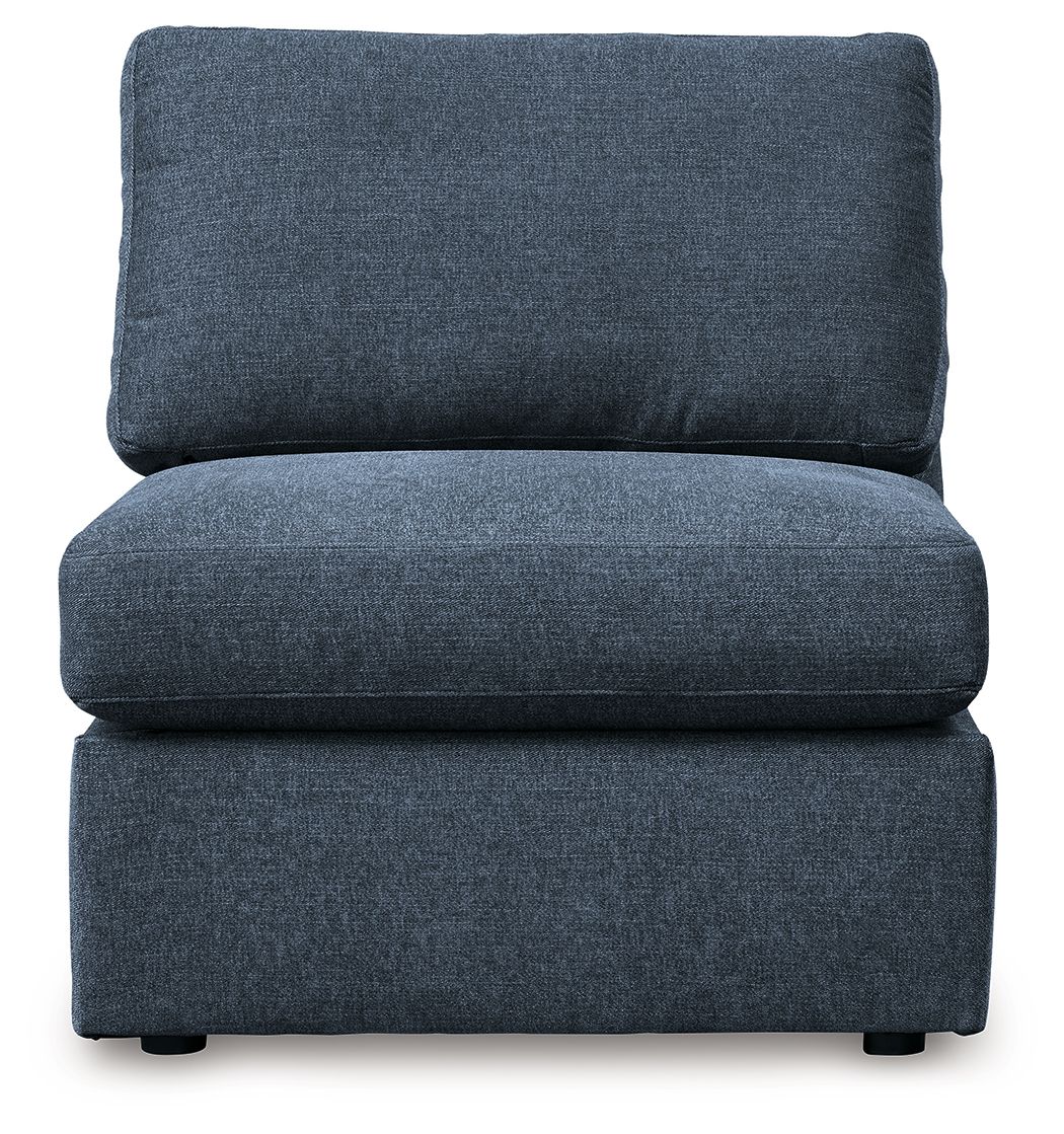 Blue armless sectional chair with tall back cushion and padded seat