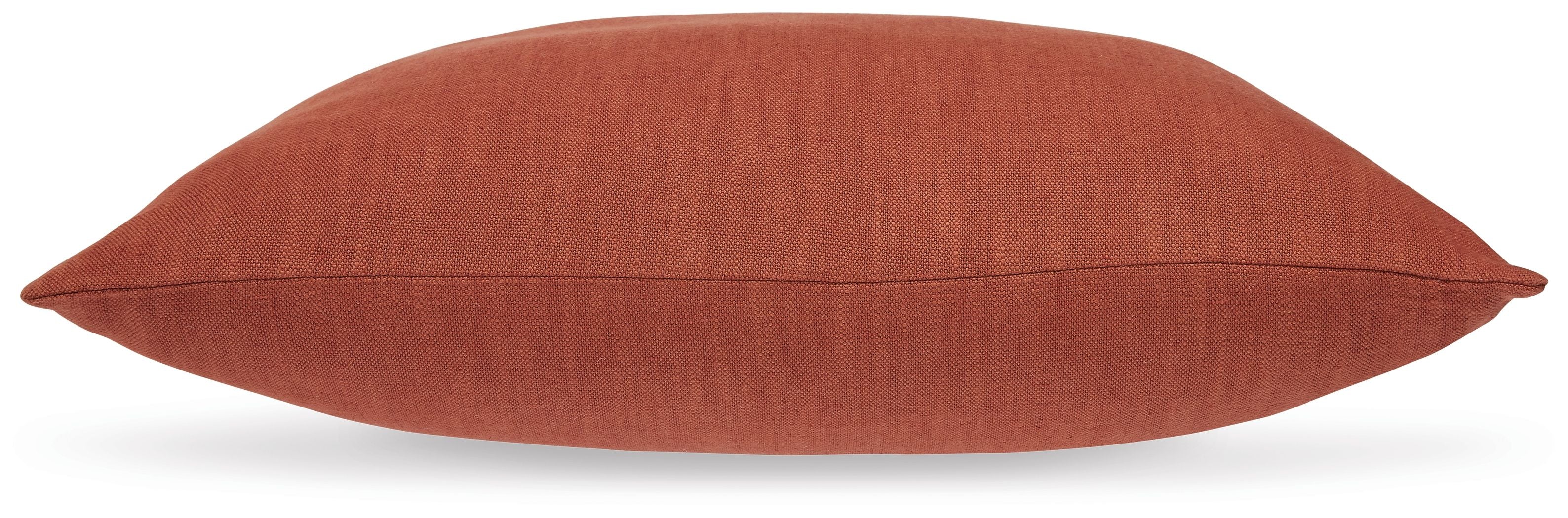 Burnt orange square throw pillow with stitched seam along the edge