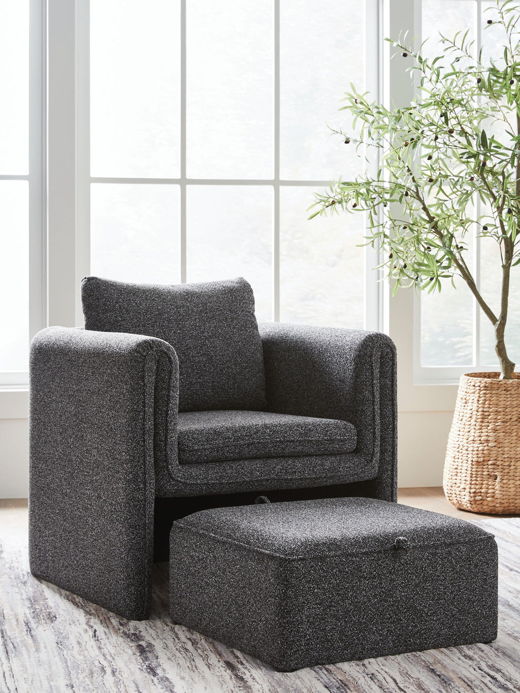 Charcoal accent chair with matching ottoman, textured fabric, curved arms, cushion back