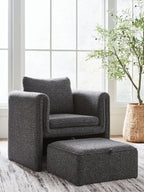 Charcoal accent chair with matching ottoman, textured fabric, curved arms, cushion back