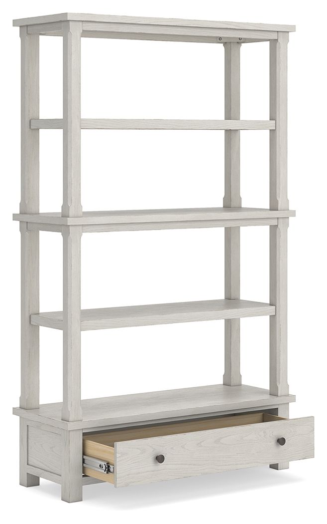 Antique white bookcase with open shelves and one lower drawer.