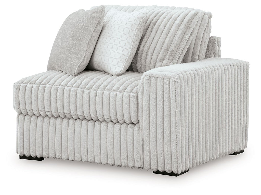Alloy RAF corner chair with ribbed light gray upholstery and two throw pillows