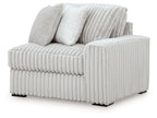 Alloy RAF corner chair with ribbed light gray upholstery and two throw pillows
