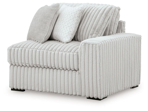 Alloy RAF corner chair with ribbed light gray upholstery and two throw pillows