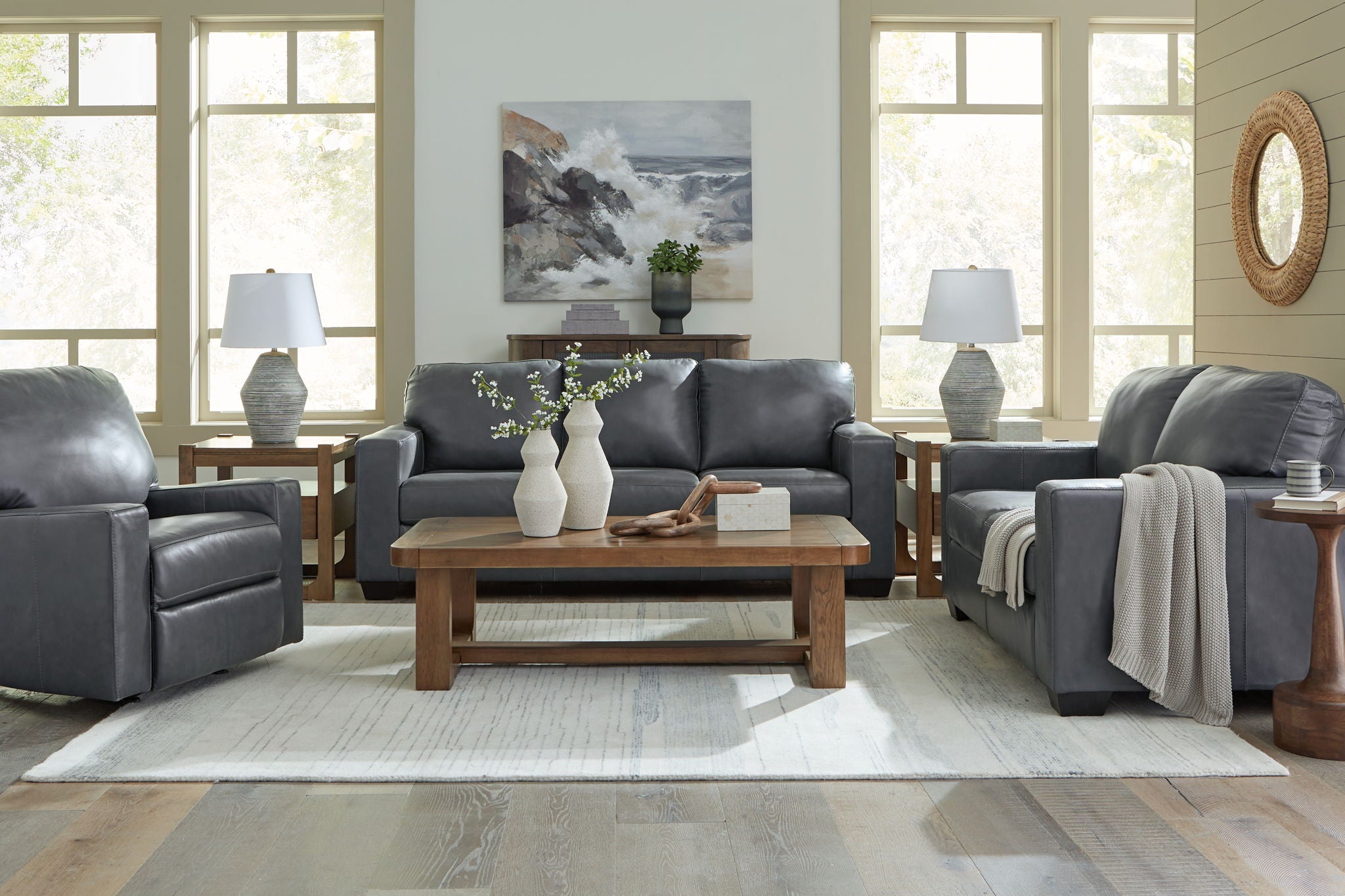 Dark gray leather sofa with tufted back and three padded seat sections