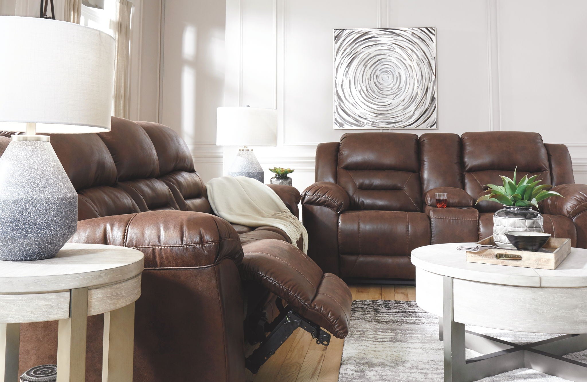 Dark brown reclining sofa with matching recliner chairs and cushioned armrests