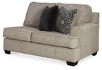 Stone fabric loveseat with square arms, black back pillows, and patterned throw cushion