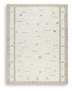 Light brown area rug with white geometric line and dot patterns