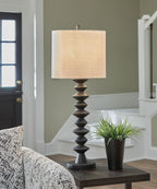 Black poly buffet lamp with beige fabric drum shade and stacked geometric base