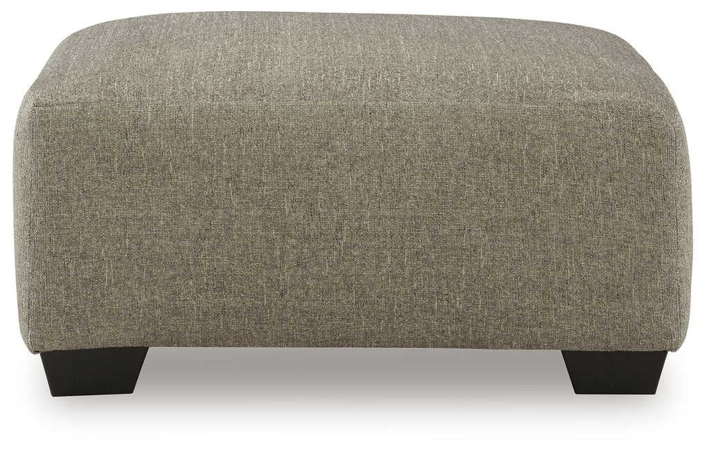 Beige oversized accent ottoman with rounded corners and dark feet
