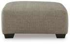 Beige oversized accent ottoman with rounded corners and dark feet