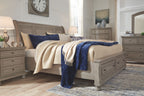 Light gray sleigh bedroom set with sleigh bed, nightstand, and dresser pieces