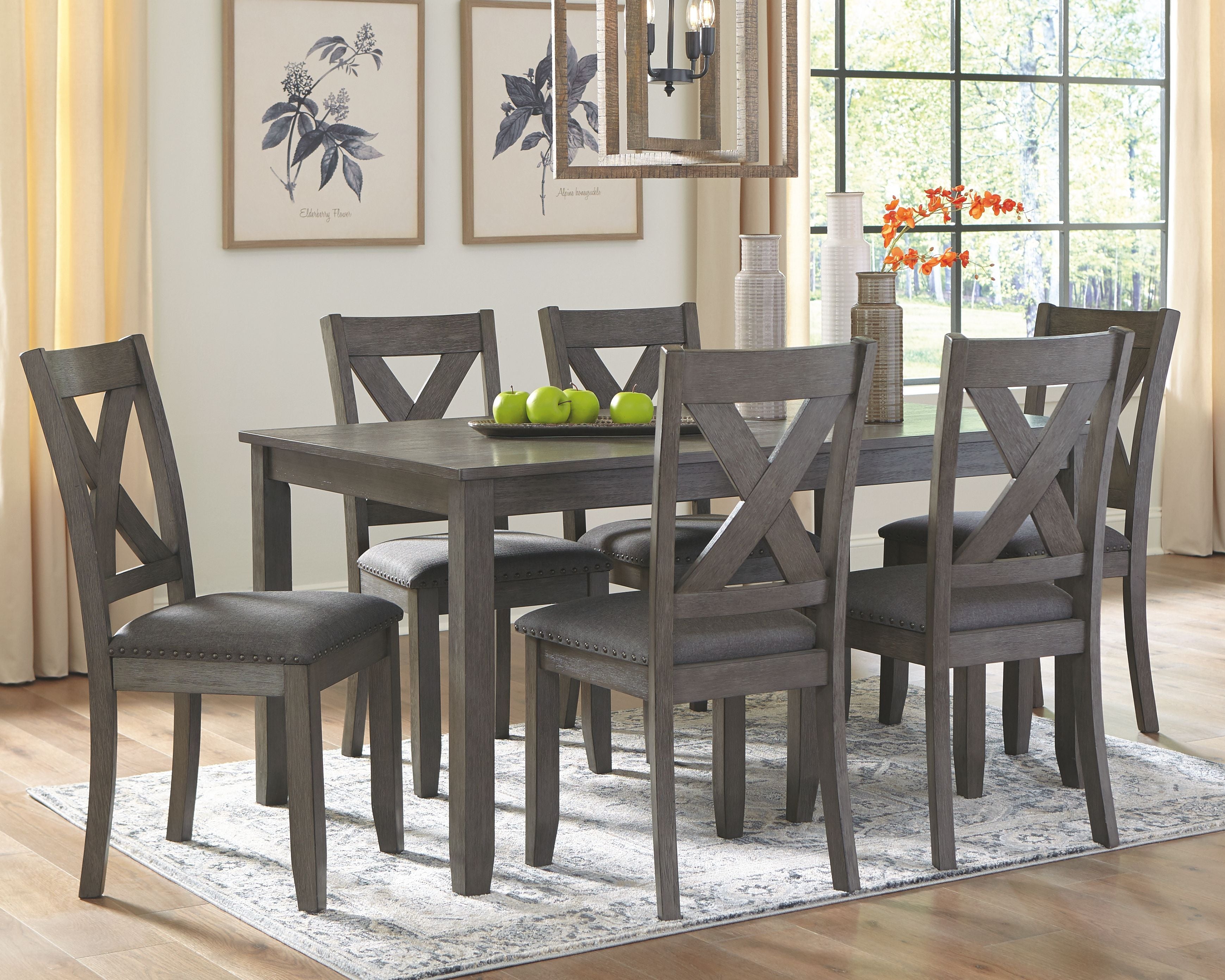 Gray rectangular dining table set with six upholstered chairs, cross-back design