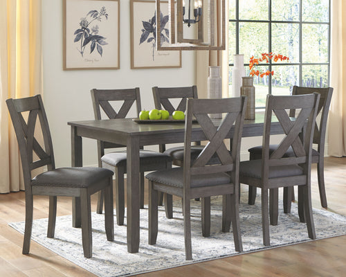 Gray rectangular dining table set with six upholstered chairs, cross-back design