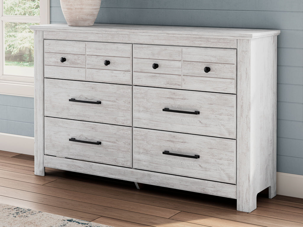 Whitewash six-drawer dresser with black bar pulls and a smooth top panel